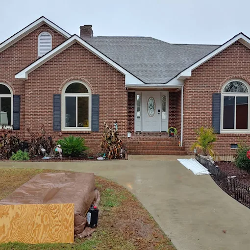 Brick ranch home with residential window film installed on front windows