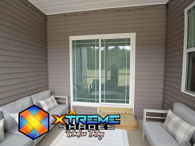 Screened porch slider with residential window film for glare control