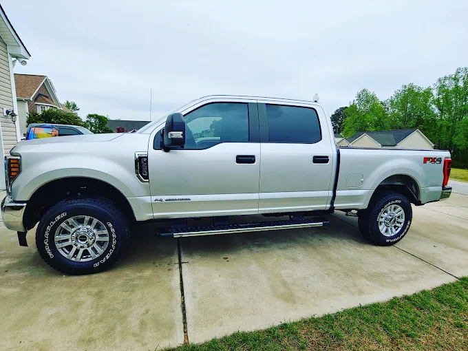 Silver Ford F-250 Super Duty with dark ceramic window tint