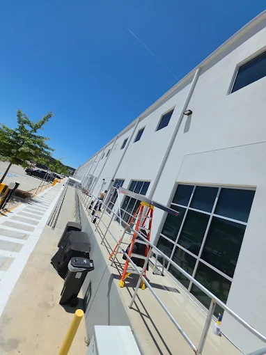 Commercial warehouse windows getting solar control film installed by Xtreme Shades