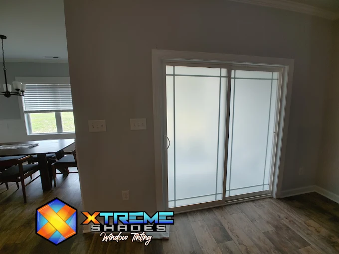 Sliding glass door with frosted privacy window film in a North Carolina home