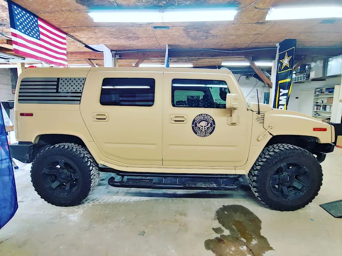 Tan Hummer H2 with American flag window graphics and tint by Xtreme Shades